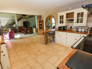 a large kitchen with a table and a dining room at Bib Knowl Farm in Littleborough