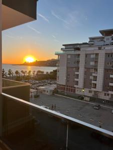 a view of a sunset from a balcony of a building at Apartments Kristi in Shëngjin