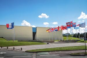 a bunch of flags in front of a building at Charmant T2 cosy au cœur de Caen Parking gratuit et arrivée autonome in Caen