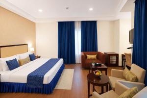 a hotel room with a bed and a living room at Hotel Amber Palace in Gurgaon +25 photos