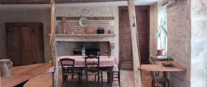 a dining room with a table and a fireplace at Gîte des petits givrés in Entrains-sur-Nohain
