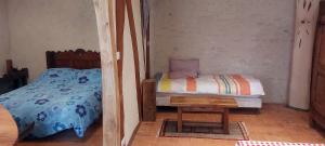a small bedroom with a bed and a table at Gîte des petits givrés in Entrains-sur-Nohain