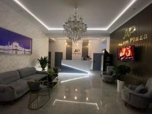 a living room with couches and a chandelier at Hotel Imam Azam in Samarkand