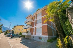 a building with a car parked in a parking lot at Charm Apartment with Balcony and Parking - Happy Rentals in Ascona
