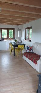 a living room with a couch and a table at Chata pod kogutem in Barczewko