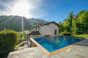 a villa with a swimming pool in the mountains at Casa dei Galli in Gravedona