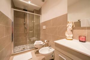 a bathroom with a shower and a toilet and a sink at Menaggio Tosca Apartments in Menaggio