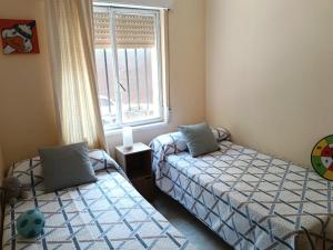 a bedroom with two beds and a window at montepino 2 in Maello +71 photos