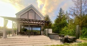 a house with a deck with a table and chairs at Hampton Zalew Zegrzyński in Cupel +49 photos