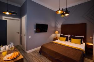 a bedroom with a bed and a table with oranges on it at REGINA Bed&Wine in Varna City