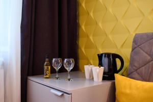 a table with two glasses and a bottle of wine at REGINA Bed&Wine in Varna City