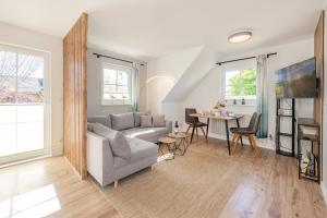a living room with a couch and a table at Ferienwohnung Strandliebe in Koserow