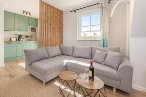 a living room with a couch and a table at Ferienwohnung Strandliebe in Koserow