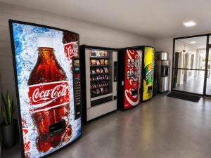 a group of cocacola soda vending machines in a room at Sunset Inn in Jacksonville