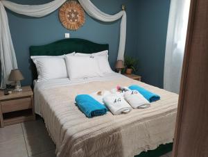 a bedroom with a bed with two towels on it at Eolos Villa in Parga