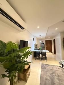a living room with a large plant and a table at Go Q Tambuli Seaside Studio in Maribago