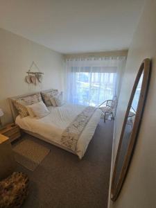 a bedroom with a large bed and a window at Jasmin Doux in Poitiers