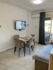 a dining room with a table and chairs at Beachfront Apartment Durres in Durrës
