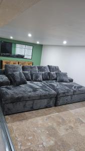 a large black couch in a room with a wall at La coconing in Vierzon +1 photo