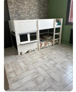 a room with two bunk beds and a wooden floor at La coconing in Vierzon