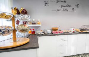 a kitchen with a counter with some food on it at Hotel Astoria in Riccione