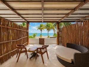 a living room with a view of the ocean at Arenika Beachfront Villa & Rooms in Puerto Morelos