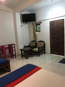 a living room with a couch and a table at Linwood Bungalow in Kandy
