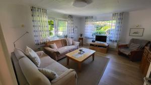 a living room with a couch and a table at Ferienwohnung Inge EG in Greetsiel