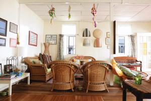 a living room with wicker chairs and a table at Kunyit 7 Lodge in Bandar Seri Begawan