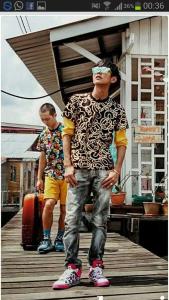 two men standing on a dock with their luggage at Kunyit 7 Lodge in Bandar Seri Begawan +18 photos