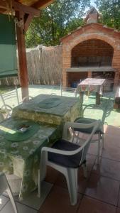 a table and chairs on a patio with a brick oven at Centrala in Vrdnik