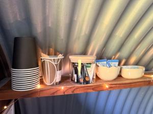 a wooden shelf with dishes and cups on it at Krummeled Rooms & Shelter by the forest in Hasle +27 photos
