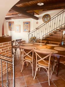 a dining room with wooden tables and a staircase at Bed And Breakfast Olimpia in San Salvatore Monferrato