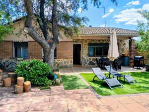 a patio with a tree and an umbrella at montepino 2 in Maello