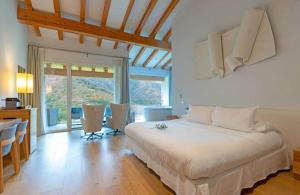a bedroom with a bed and a table and chairs at Arantza Hotela - Boutique Hotel "Adults Only" in Arantza +30 photos