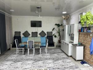 a living room with a dining room table and chairs at Friendly House in Bokonbayevo