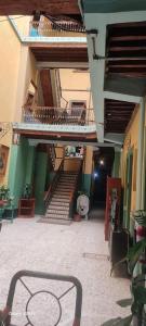 a building with stairs and a table in a courtyard at Hotel Republica in Mexico City