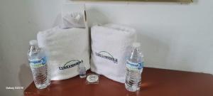 two towels and two bottles of water on a table at Hotel Republica in Mexico City