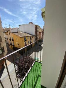 a balcony with a view of a city with buildings at Grampy Boutique Hostal - Zaragoza Centro in Zaragoza +18 photos