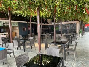 a restaurant with tables and chairs and plants at Perch Hotel & Suites in Lagos
