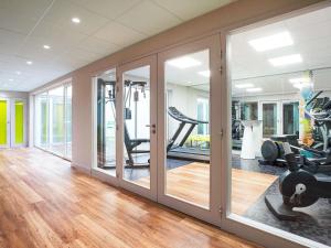a gym with treadmills and elliptical machines at ibis Styles Deauville Centre in Deauville