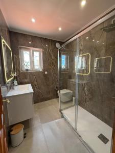 a bathroom with a shower and a sink at Castelo Sereno in Quinta do Conde +32 photos