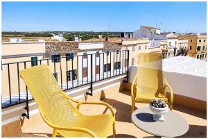 two chairs and a table on a balcony at Hotelet Bastio 12 in Ciutadella