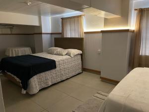 a bedroom with a bed with a black comforter at Espaço da Mariah in Arroio do Meio +32 photos