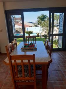 a dining room with a table and a view of the ocean at Espaço da Mariah in Arroio do Meio
