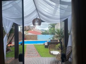 a view of a patio with a white canopy and chairs at Espaço da Mariah in Arroio do Meio