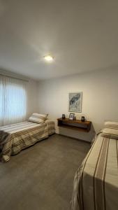 a bedroom with two beds and a desk in it at Casas Urbanas Apart Hotel in Jesús María +47 photos