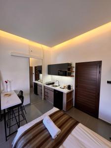 a kitchen with a bed and a table in a room at Railway Studio 1 - Cozy Studio in Byblos - Central Location in Jbeil