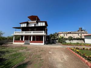 a large building with a balcony on top of it at CP Villa Resort in Bhāweghar +7 photos