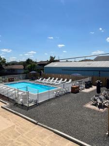 a swimming pool with lounge chairs and a swimming pool at Shore Point Motel in Point Pleasant Beach +17 photos